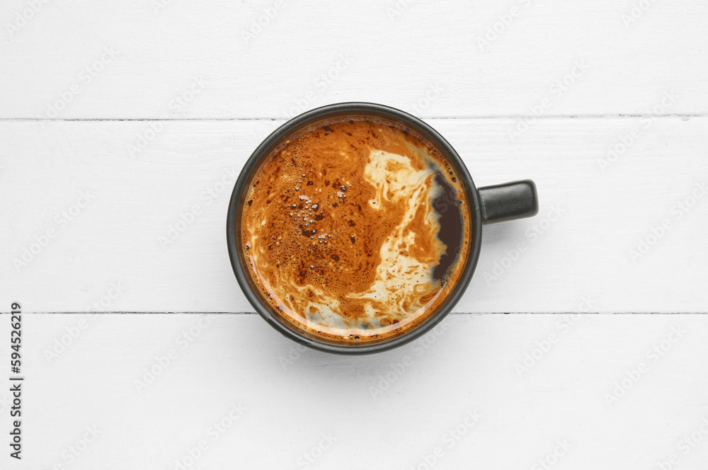 Cup of hot coffee on white wooden background