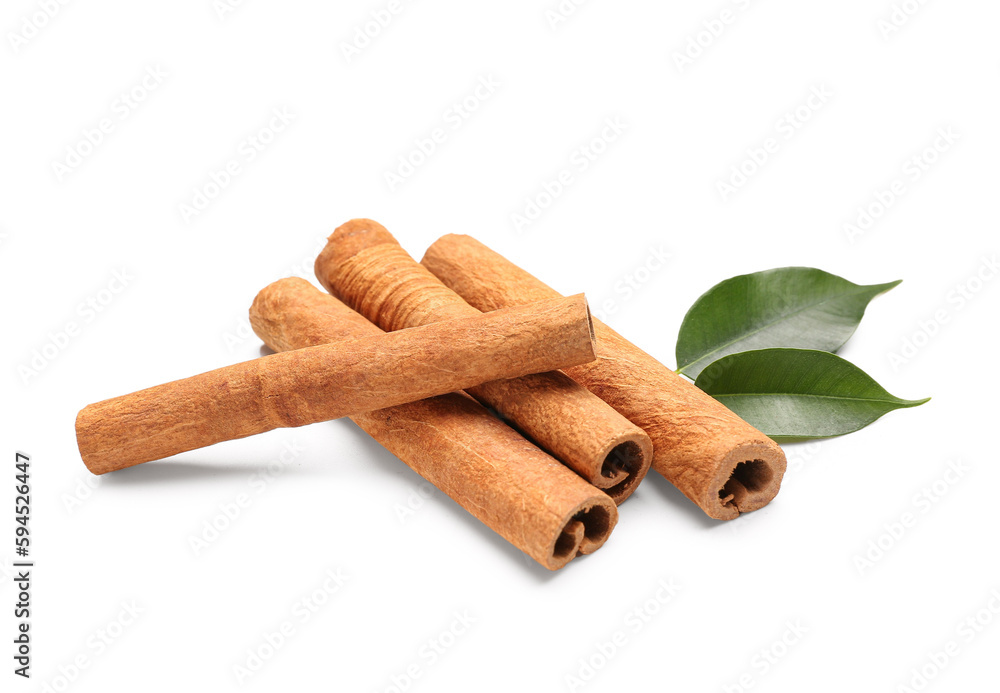 Cinnamon sticks with leaves on white background