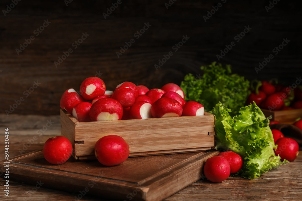 Box with fresh radish on wooden background