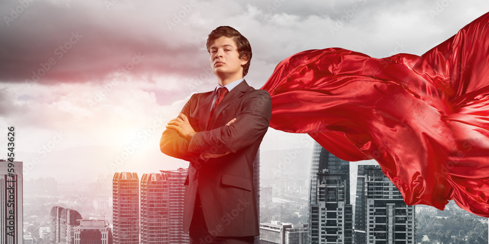 Concept of power and sucess with businessman superhero in big city