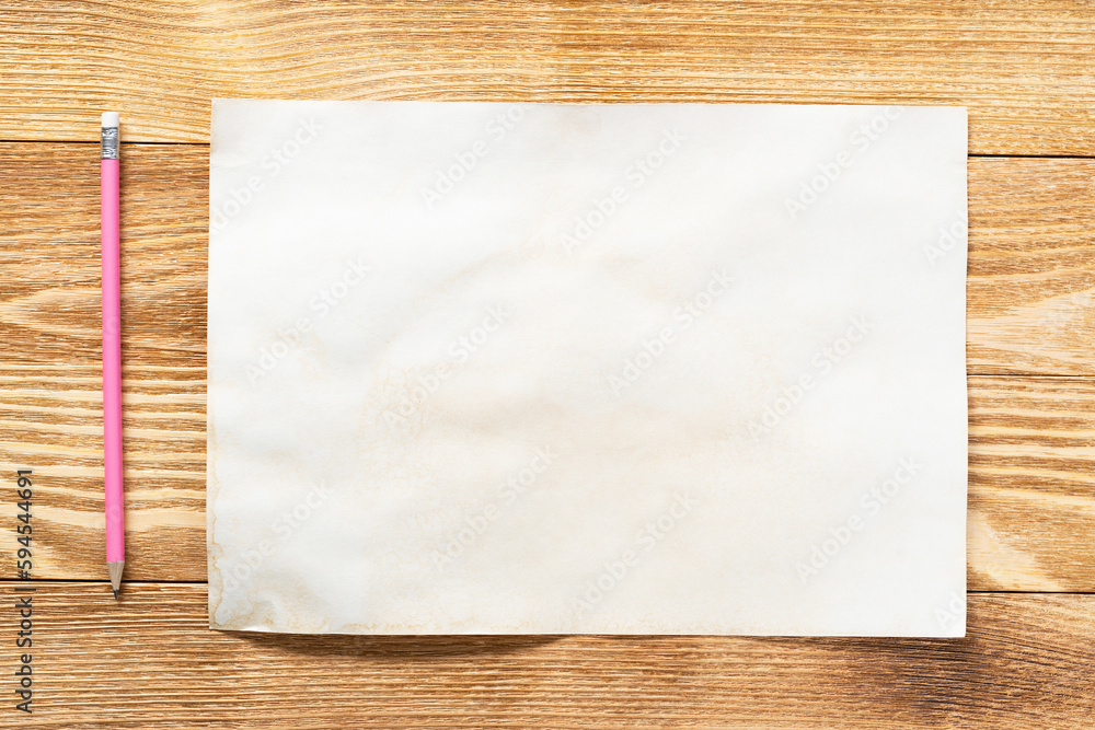 Sheet of paper lying on wooden table