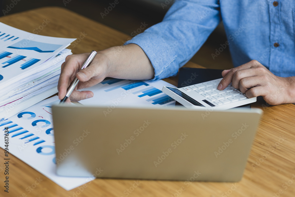 Businessman working with business report papers on office desk, financial chart analysis with calcul