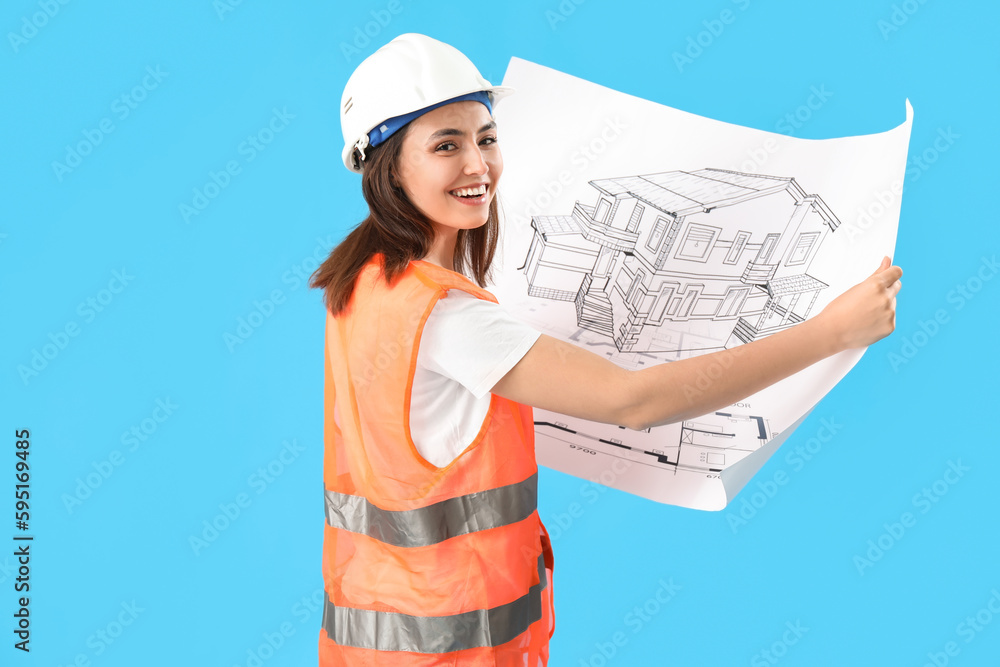 Female engineer with drawing on blue background