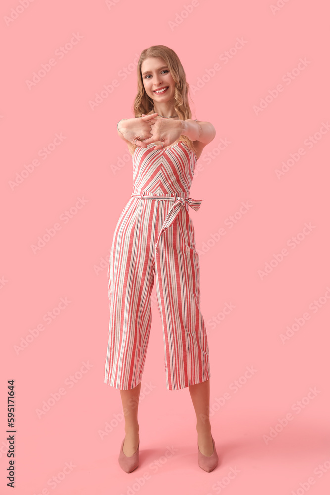 Young woman on pink background