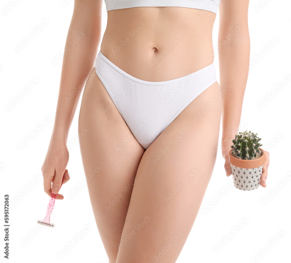 Young woman in underwear with razor and cactus on white background