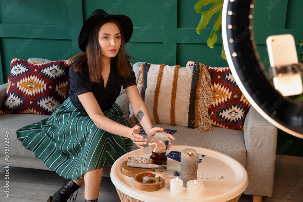 Young fortune teller recording video for blog at home