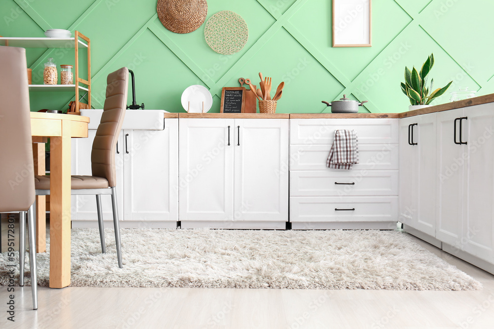 Interior of modern kitchen with white counters