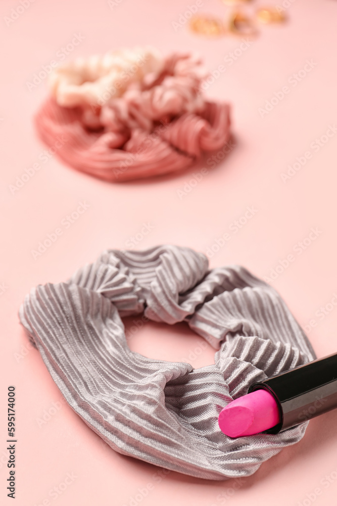 Stylish scrunchies and lipstick on pink background