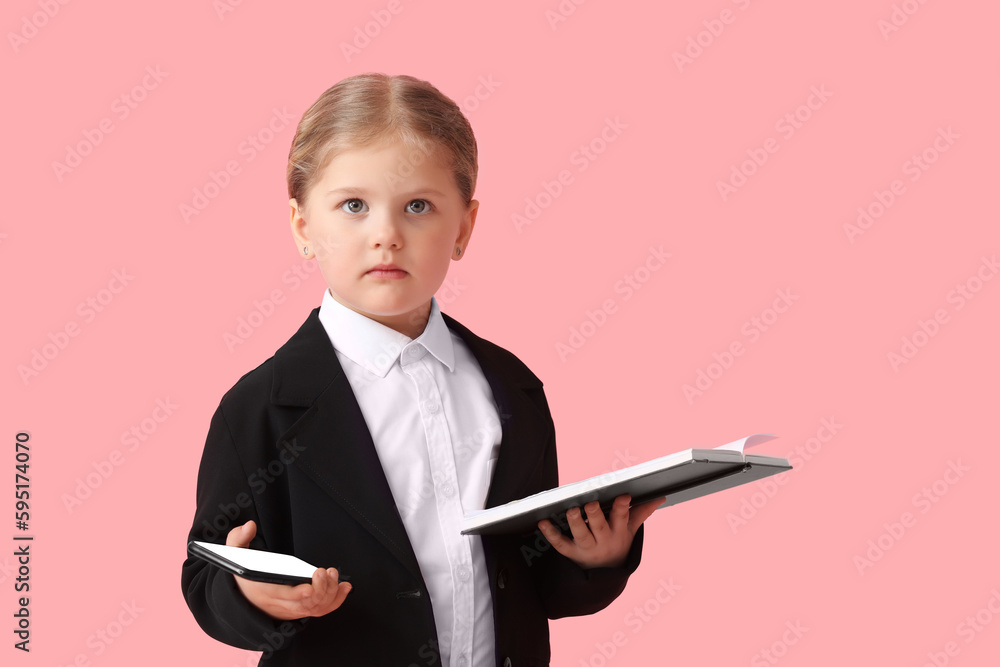 Funny little businesswoman with mobile phone and notebook on pink background