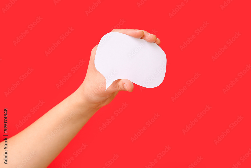 Woman holding blank speech bubble on red background