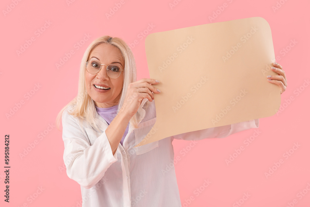 Mature woman with blank speech bubble on pink background