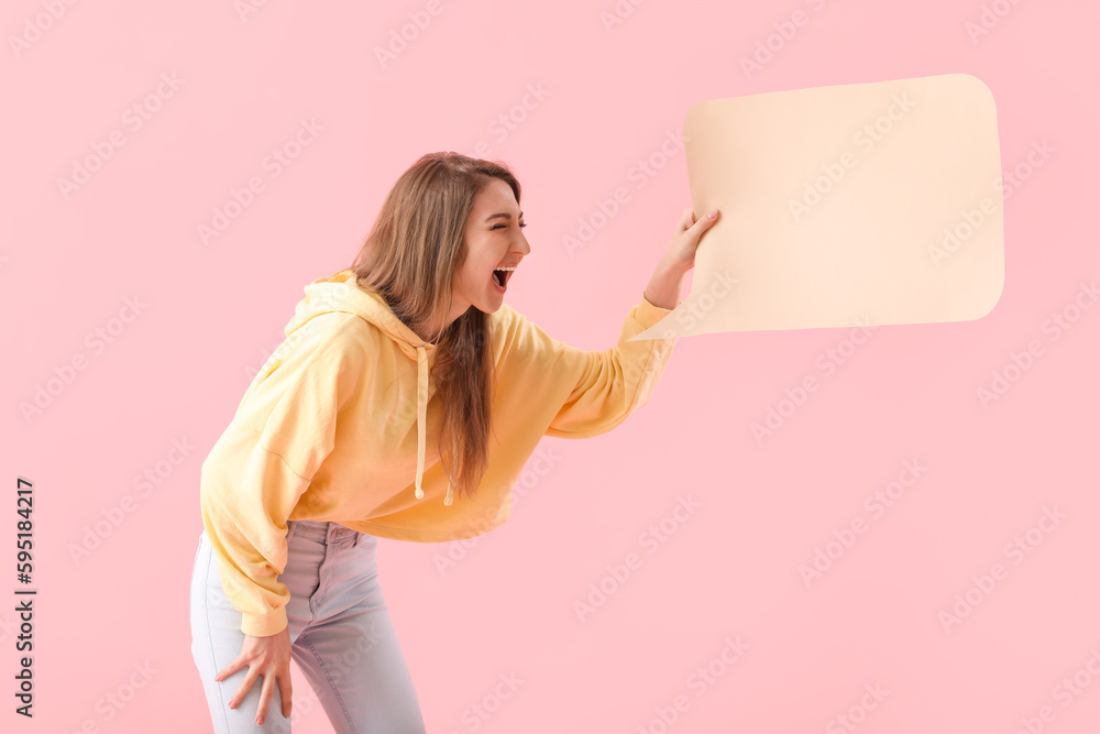 Young woman with blank speech bubble on pink background