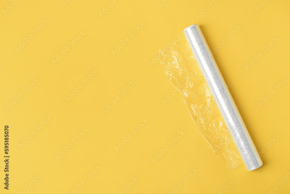 Roll of stretch wrap on yellow background