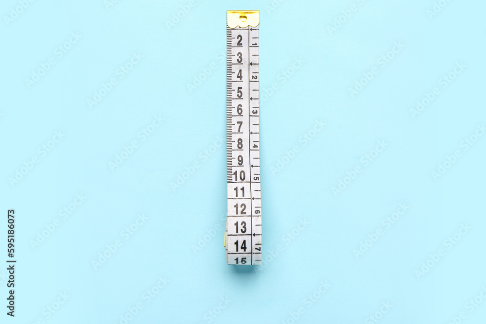 White measuring tape on blue background