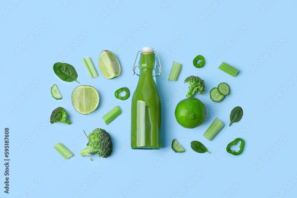 Glass bottle of tasty green juice and ingredients on blue background