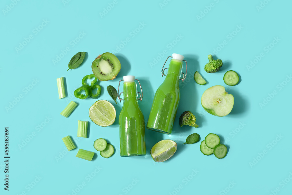 Glass bottles of tasty green juice and ingredients on turquoise background