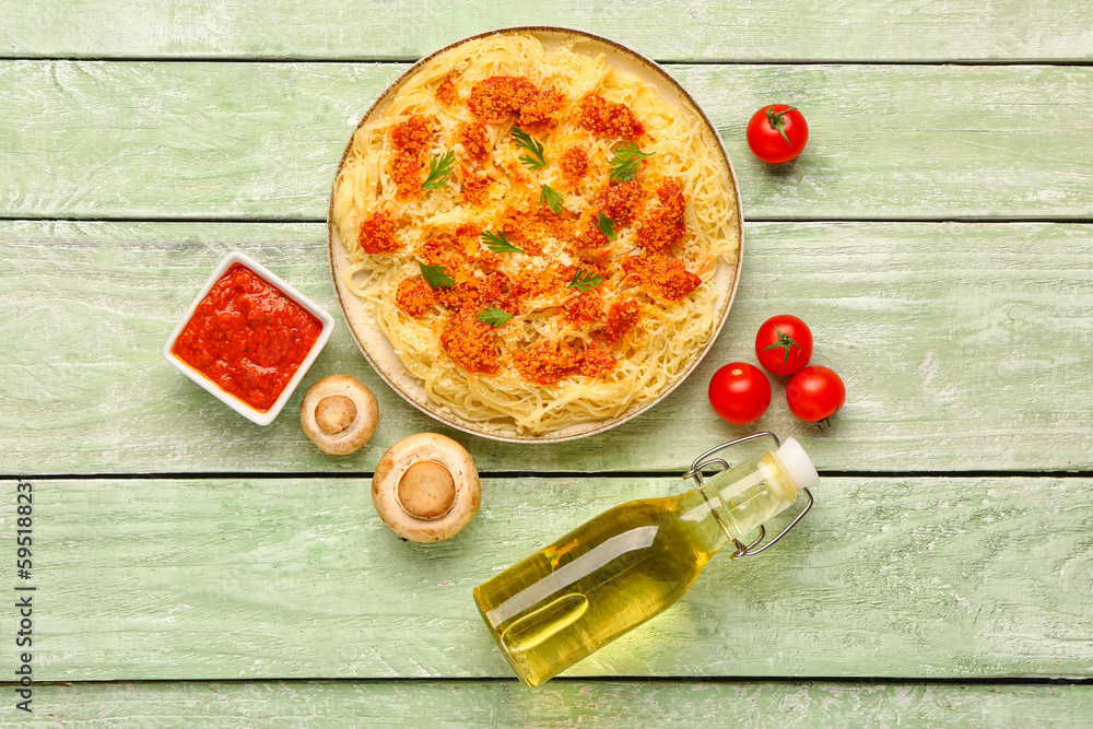 Plate of tasty Italian pasta with Parmesan cheese and ingredients on light wooden background