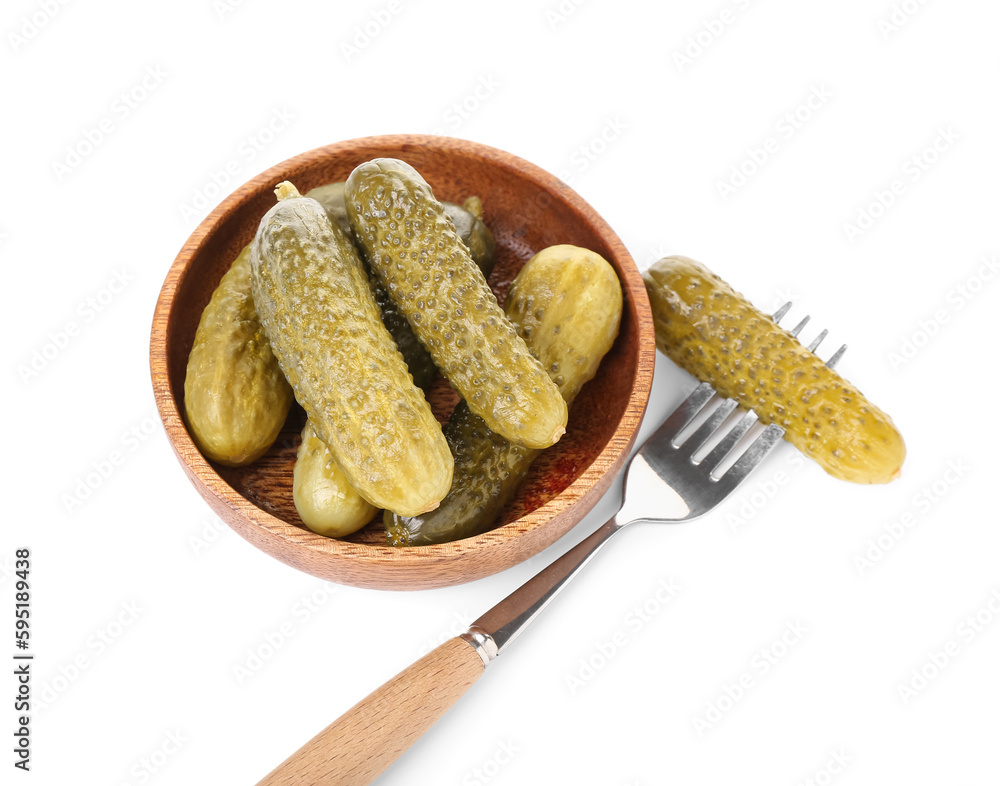 Bowl and fork with tasty fermented cucumbers on white background