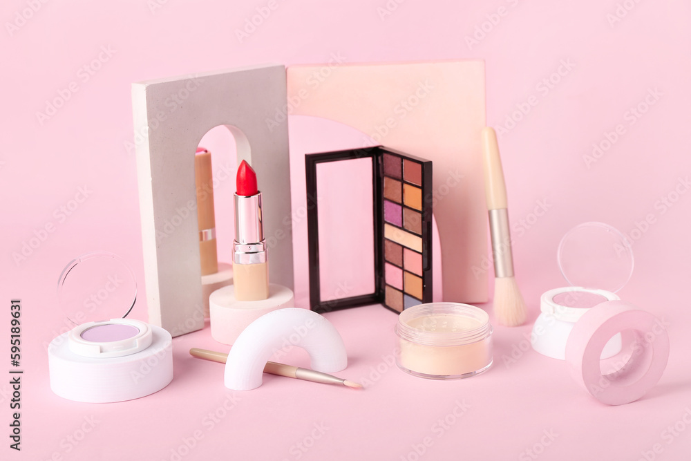 Decorative plaster podiums and cosmetics on pink background