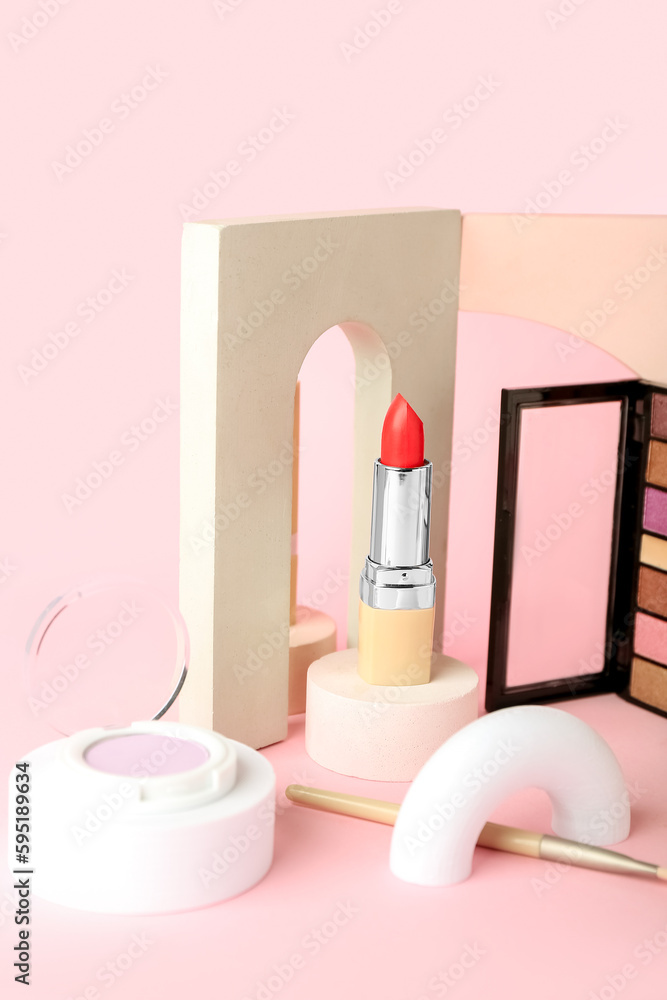 Decorative plaster podiums and cosmetics on pink background