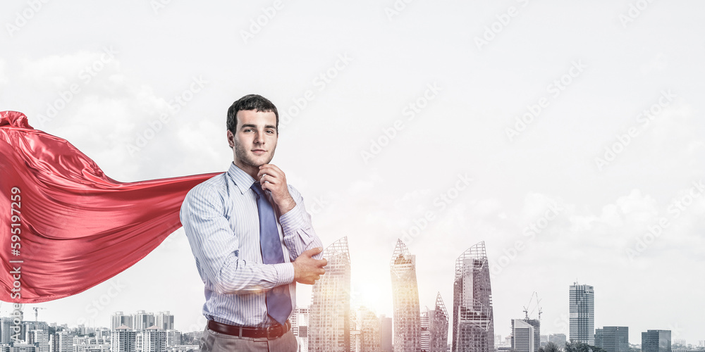 Concept of power and sucess with businessman superhero in big city