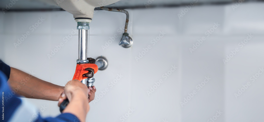 plumber at work in a bathroom, plumbing repair service, assemble and install concept.