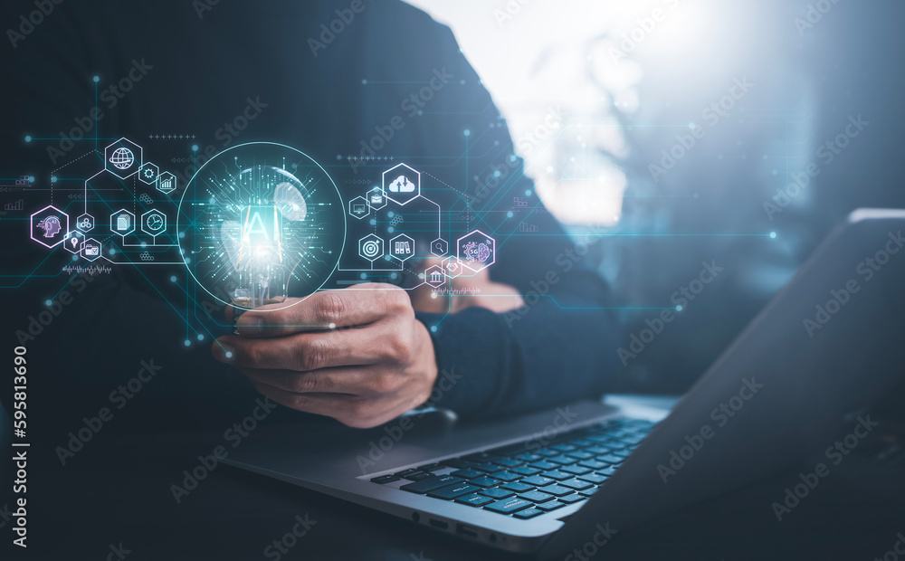 Businessman holding glowing light bulb with AI Data Management System on the computer, Hands working