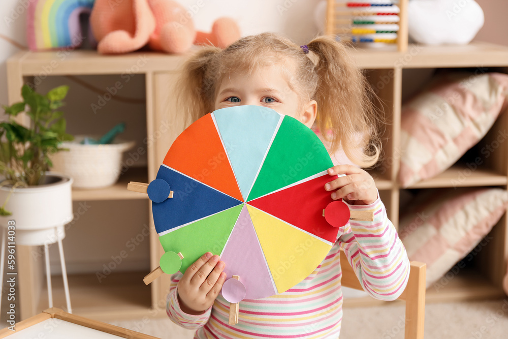 Cute little girl with matching game at home