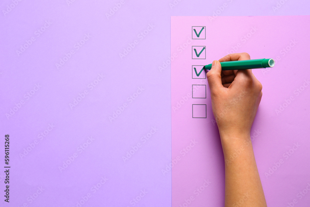 Woman marking on checklist box with green marker