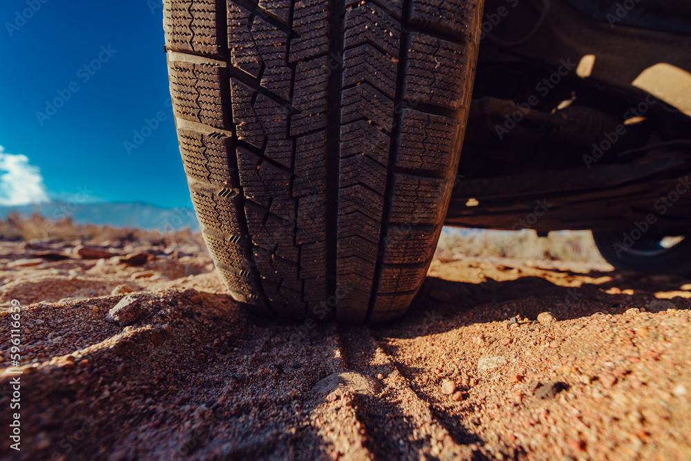 Car wheel on sand close-up view