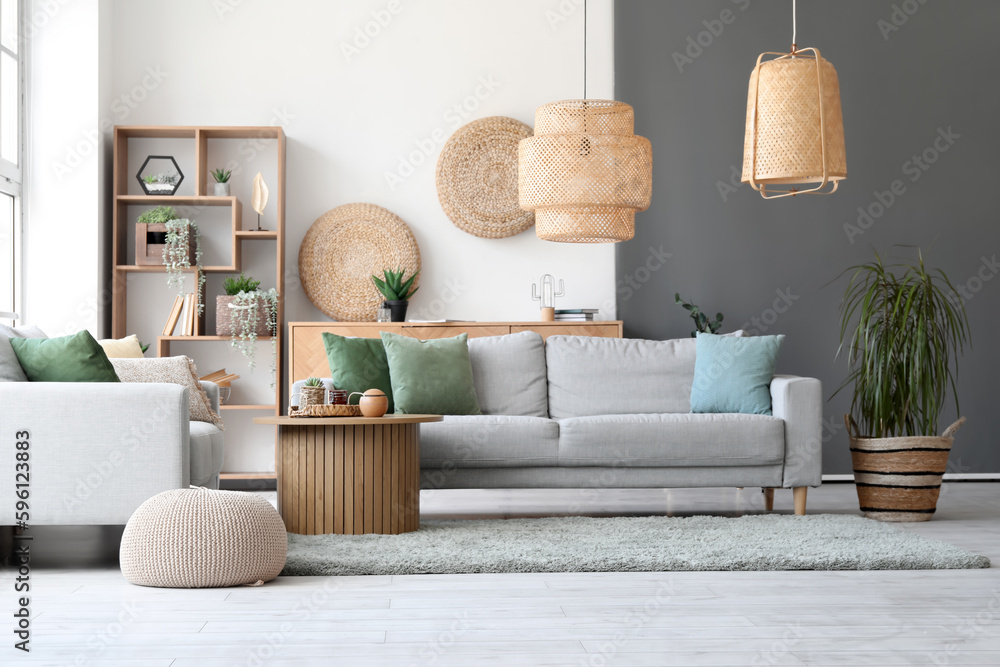 Interior of stylish room with cozy grey sofas and coffee table on soft rug