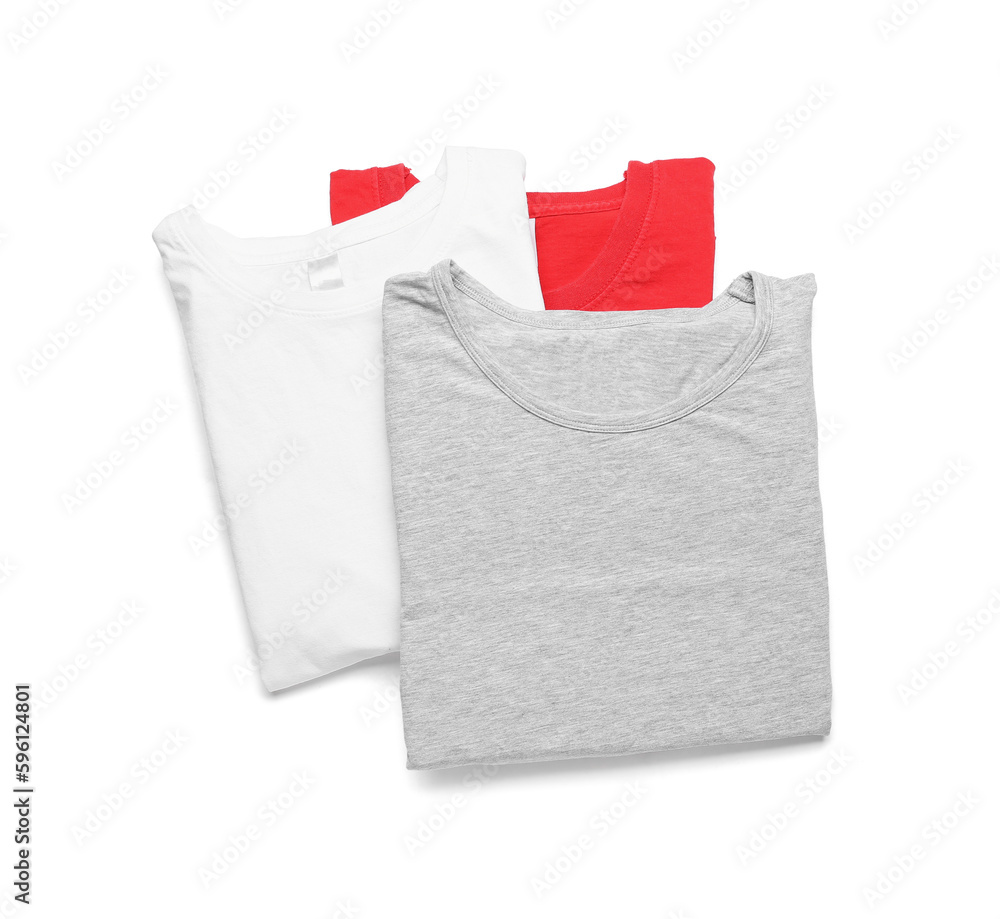 Folded stylish t-shirts on white background