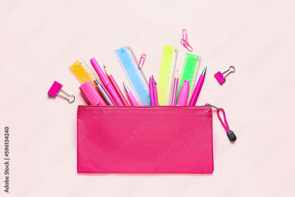 Colorful stationery supplies on pink background