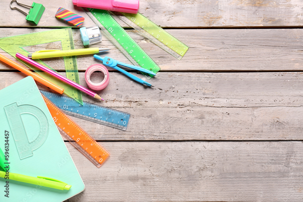 Colorful stationery supplies on wooden background