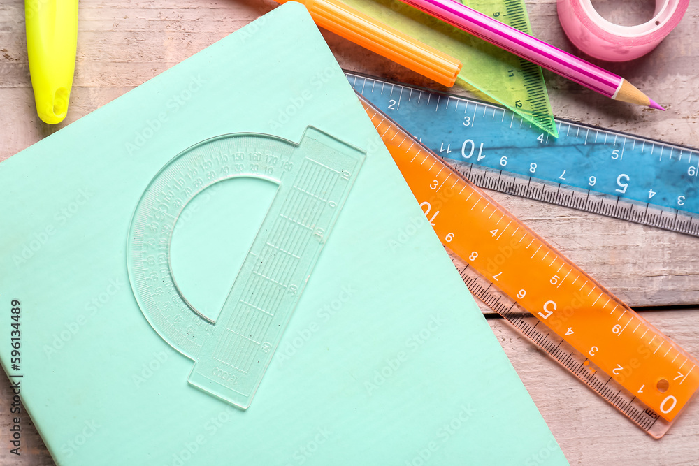 Colorful stationery supplies on wooden background