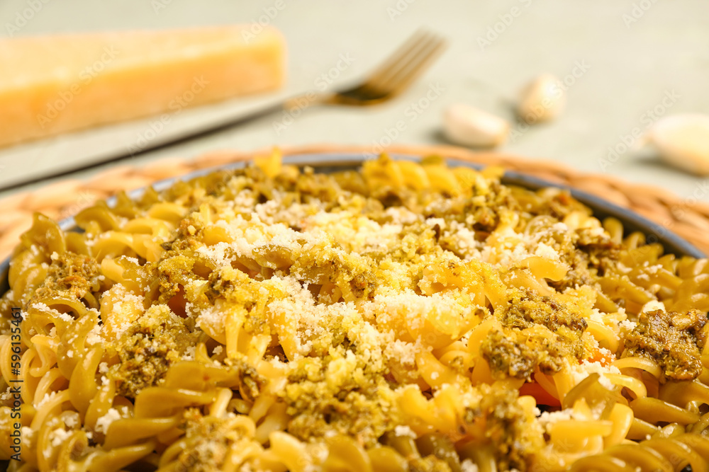 Plate of tasty Italian pasta with Parmesan cheese on table, closeup