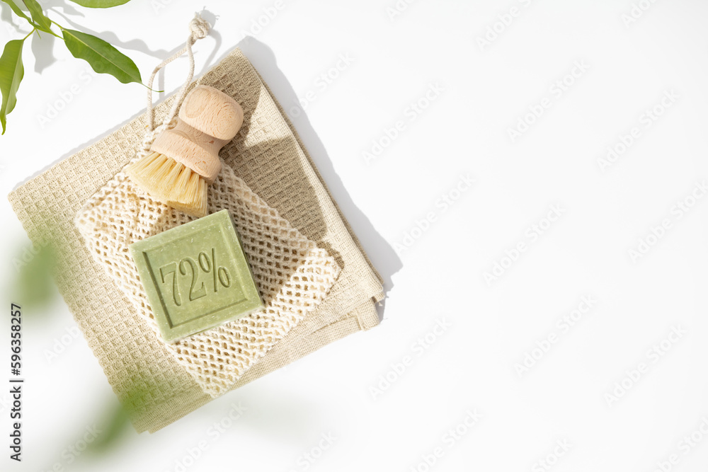 Zero waste home cleaning concept - Natural soap, bamboo dish brush, towel on white background