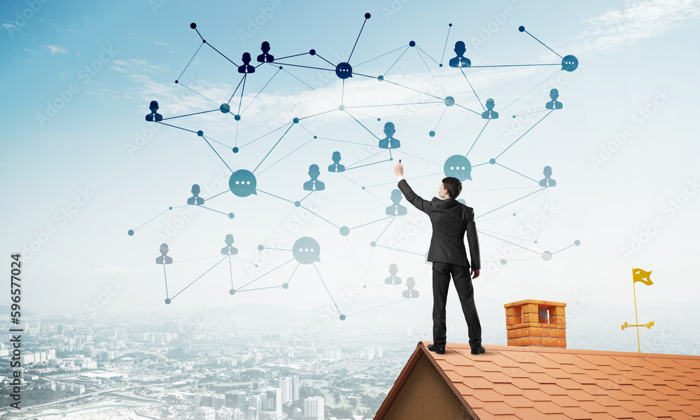 Businessman on house roof presenting networking and connection concept. Mixed media