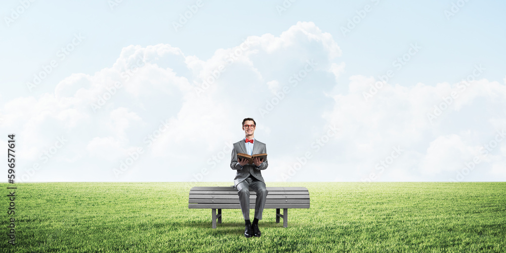 Young businessman or student studying the science in summer park