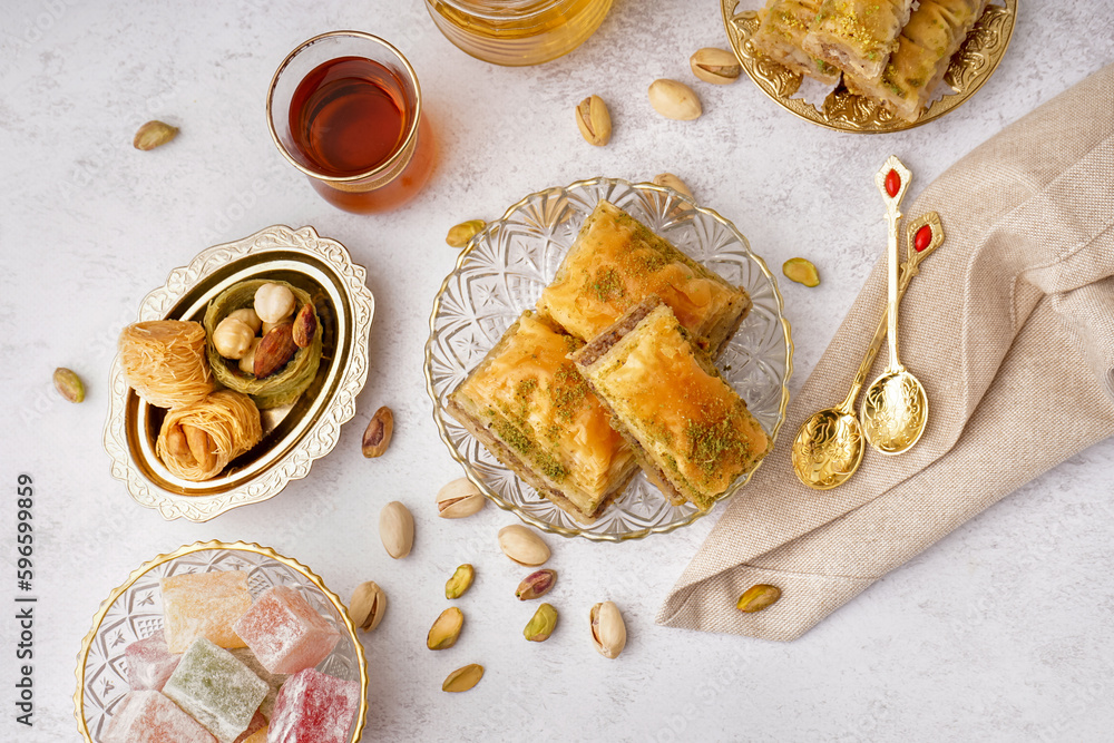 Bowl with tasty baklava on light background