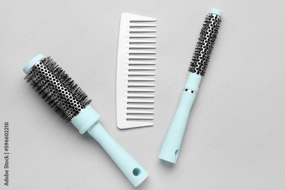 Hairdressers brushes on grey background