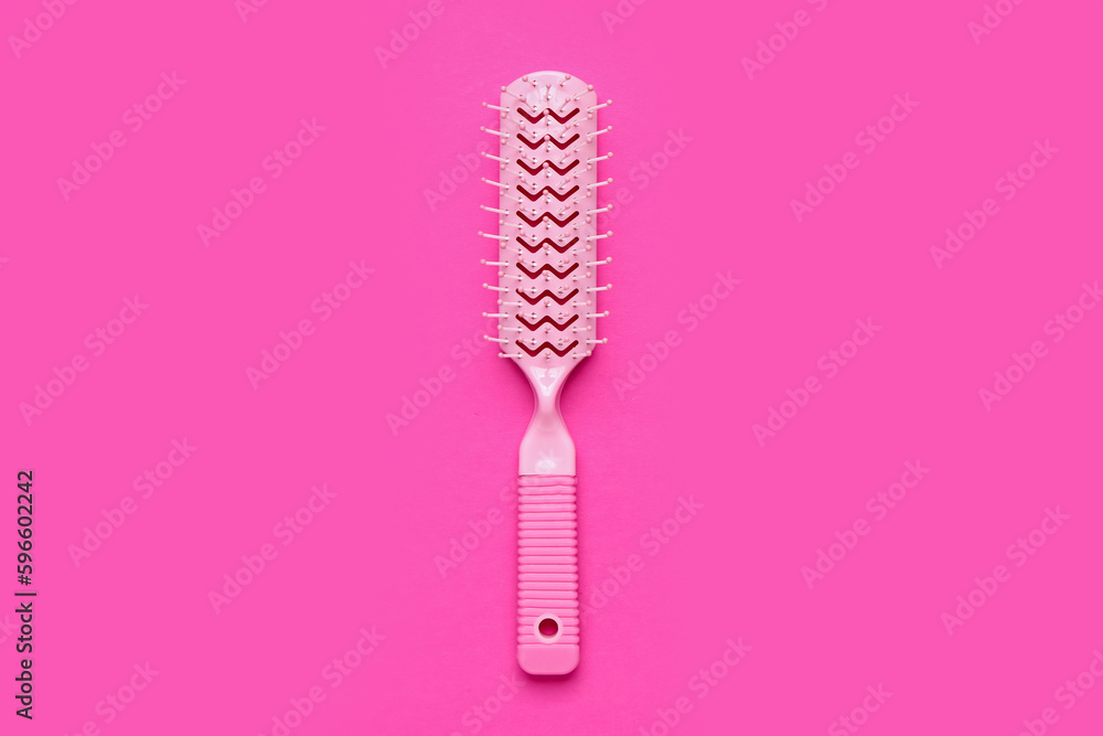 Hair brush on pink background