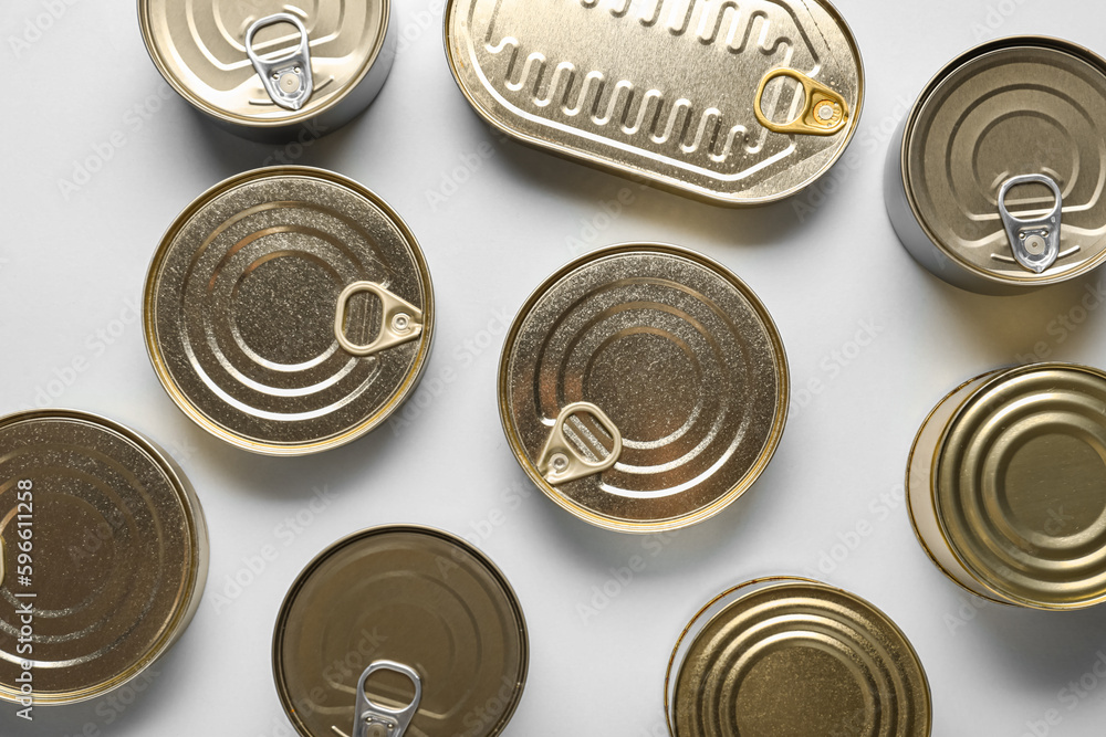 Assortment of tin cans with fish on white background