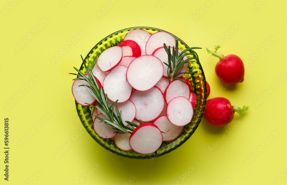 Bowl with sliced radish and rosemary on yellow background