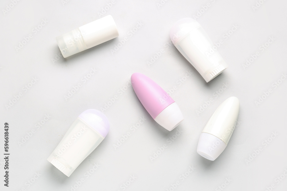 Different deodorant bottles on white background