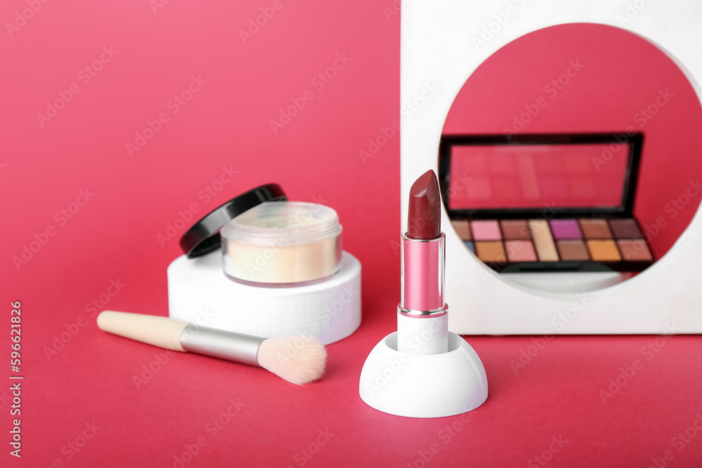 Decorative plaster podiums and cosmetics on red background