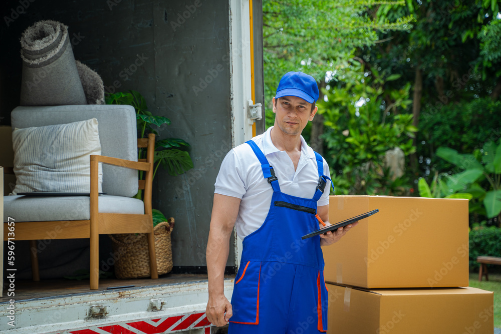 Moving company employee checks boxes in a small truck before sending them to the homeowner.