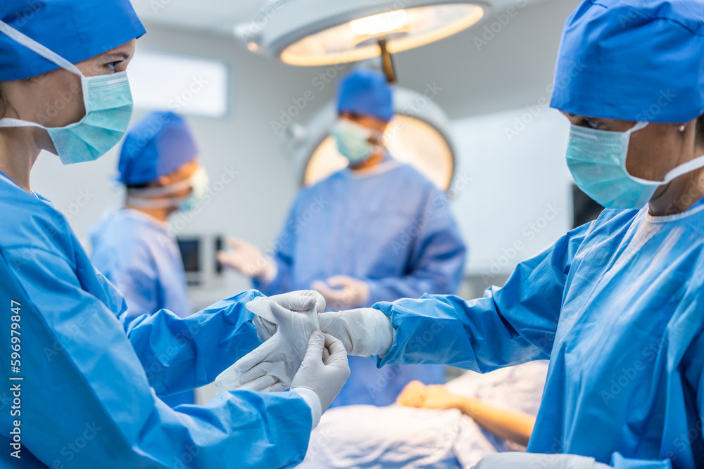 Professional doctors performing surgical operation in operating room. 