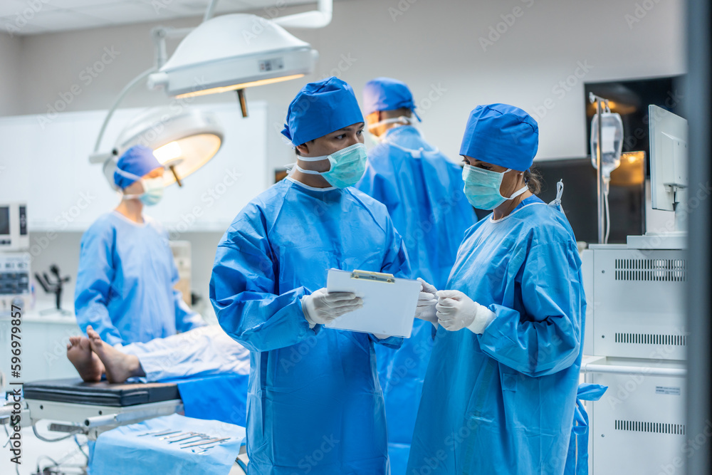 Professional doctors performing surgical operation in operating room. 