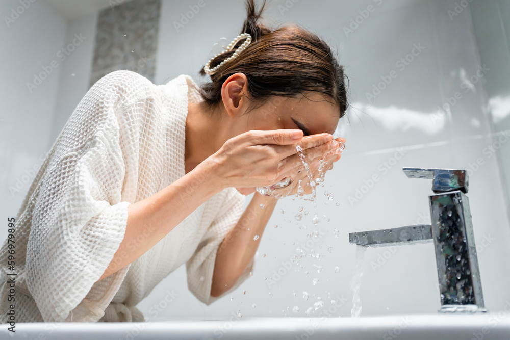 Asian beautiful woman washing her clean face with facial foam and water. 